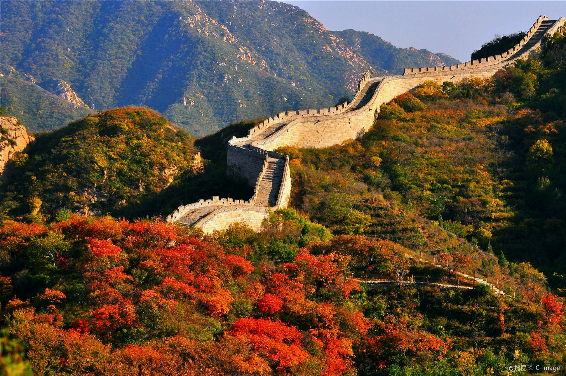  Great Wall winding through mountain slopes covered in autumn foliage near Beijing.