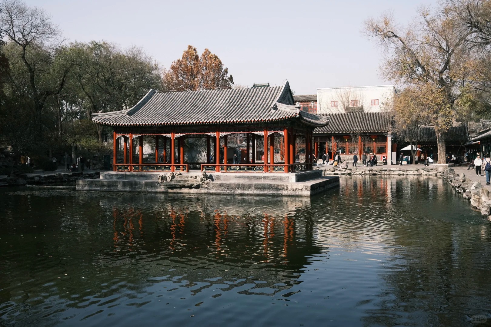 Red pavilion reflected in a pond at Prince Gong's Mansion garden in Beijing.