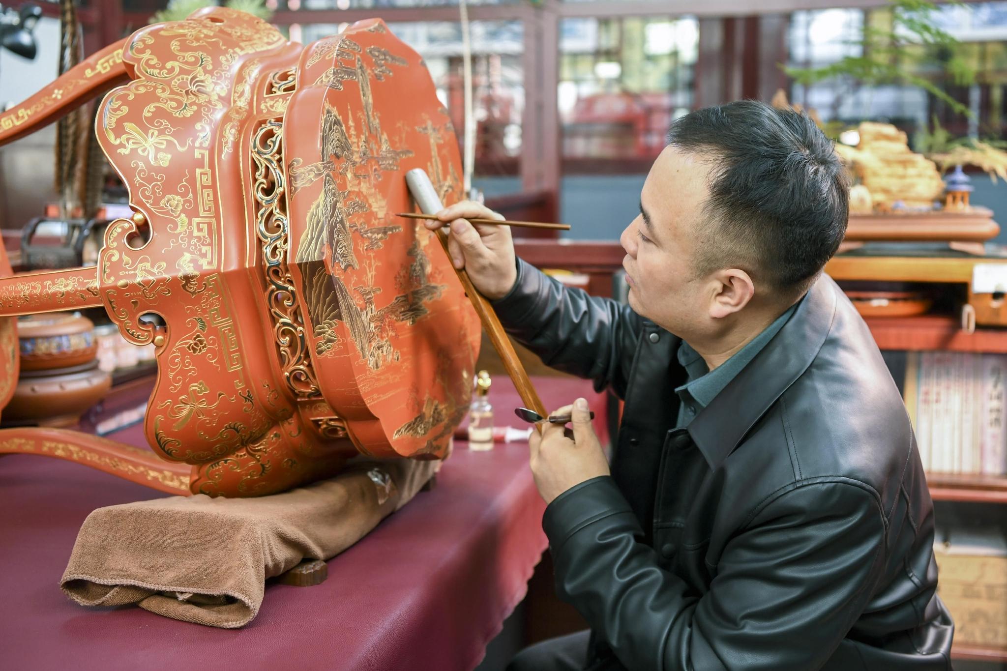 An artisan works on lacquerware, continuing a craft associated with Pingyao's cultural life.
