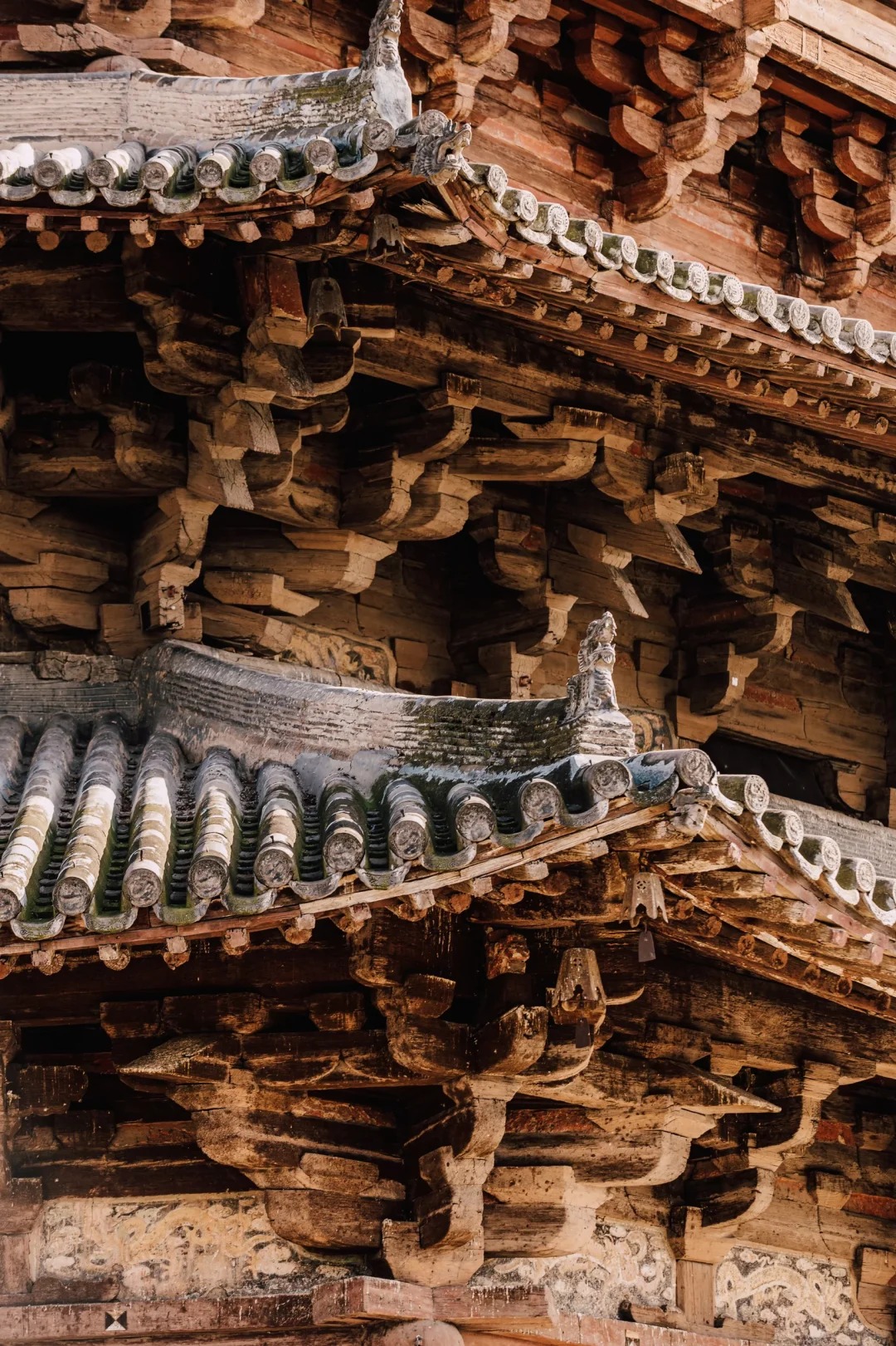 Layered bracket sets transfer the tower's weight through an intricate timber framework.
