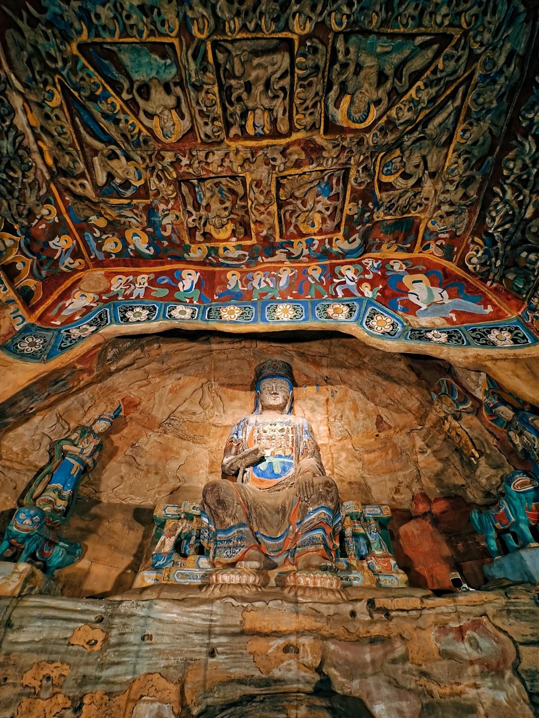 Painted ornament and sculpture meet in one of Yungang's richly decorated cave interiors.